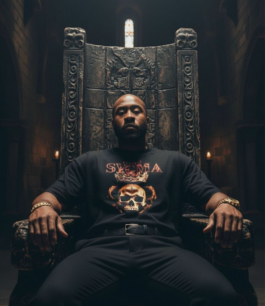 Man sitting on a throne wearing a black sweatshirt with a graphic design.