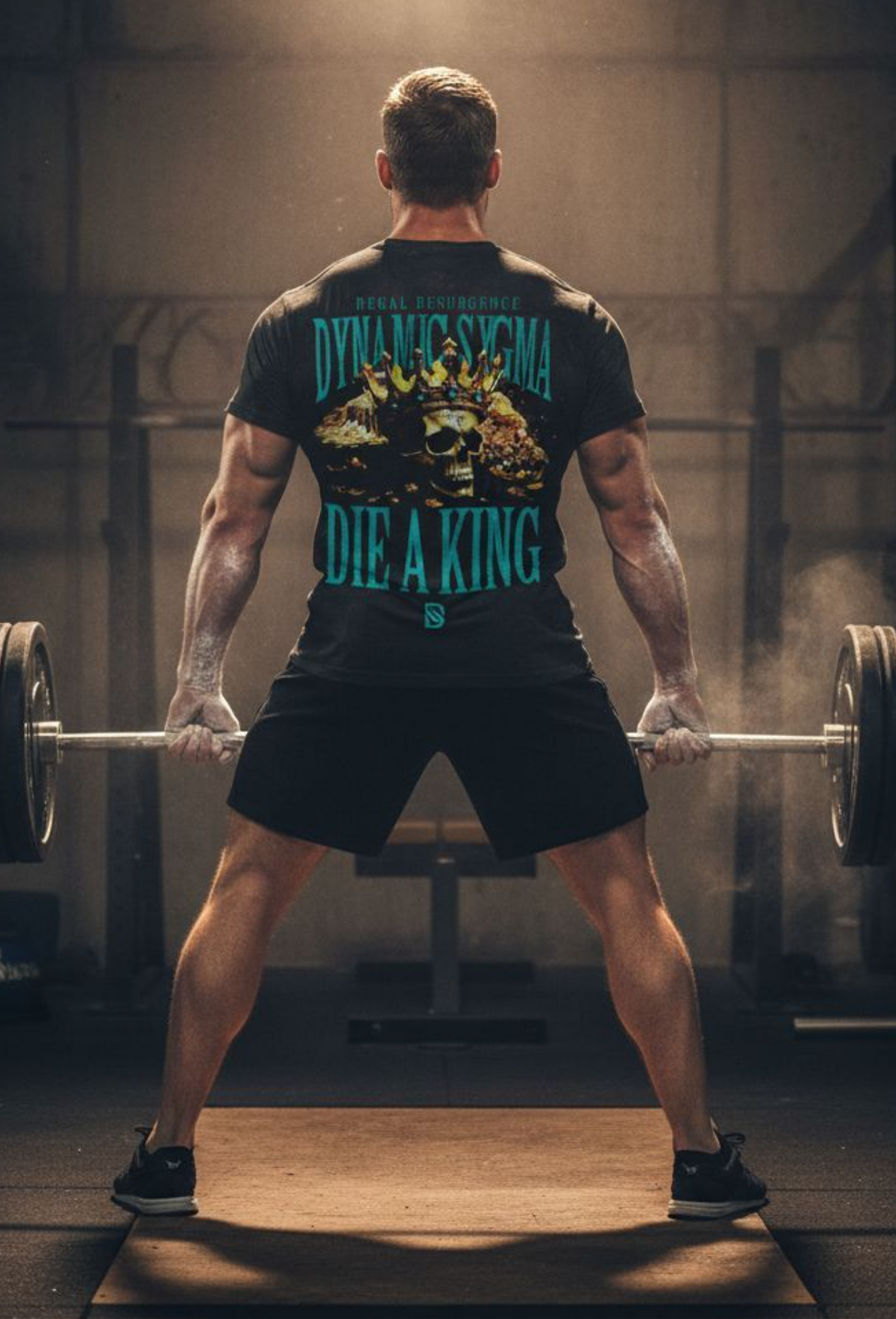 Man lifting weights in a gym wearing a black t-shirt with graphic design.