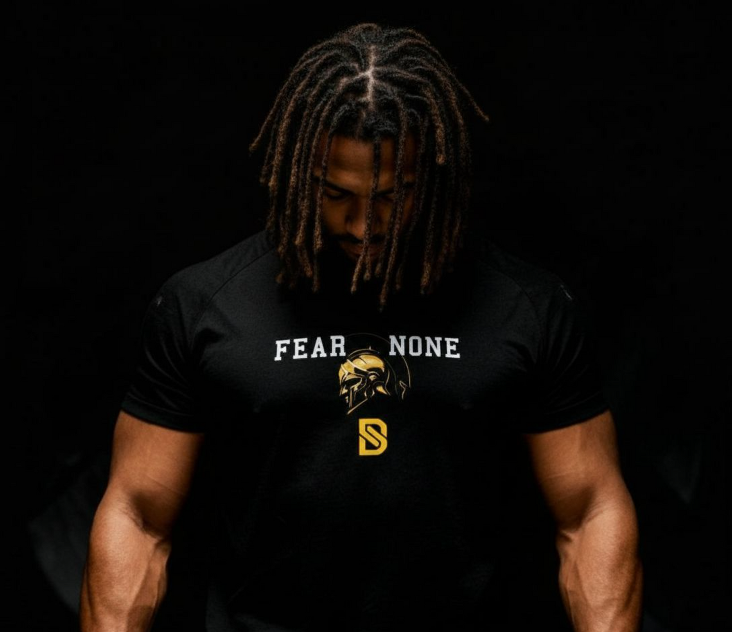 Person wearing a black t-shirt with 'FEAR NONE' text and logo on a dark background