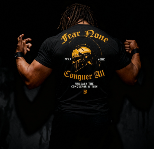 Person wearing a black t-shirt with gold and white text and graphics on the back.