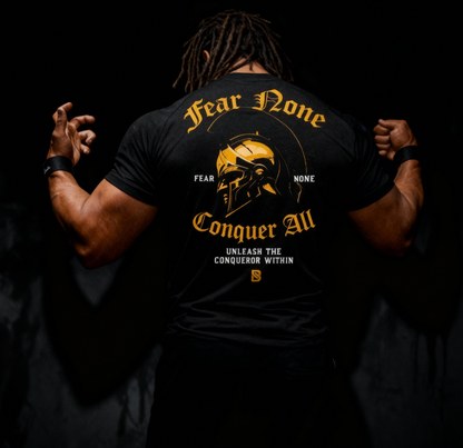 Person wearing a black t-shirt with gold and white text and graphics on the back.