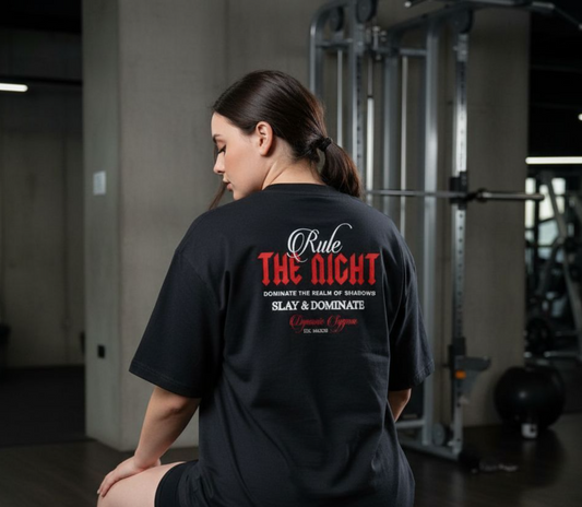 Person wearing a black t-shirt with motivational text in a gym setting